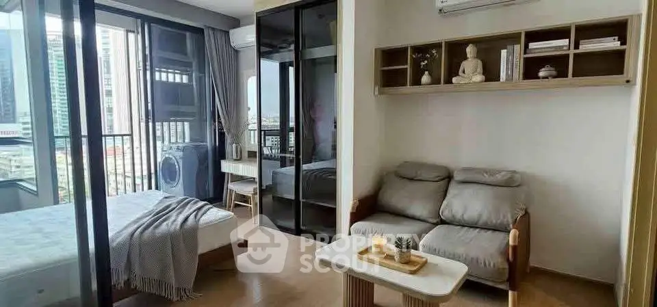Modern apartment with cozy living area and bedroom, featuring large windows and city view.