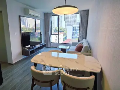 Modern living room with city view, stylish furniture, and elegant lighting in a high-rise apartment.