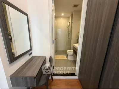 Modern apartment with sleek bathroom and stylish vanity area, perfect for urban living.
