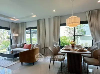 Elegant living and dining area with modern decor and large windows