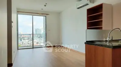Modern apartment with open layout and city view, featuring wooden floors and built-in shelves.