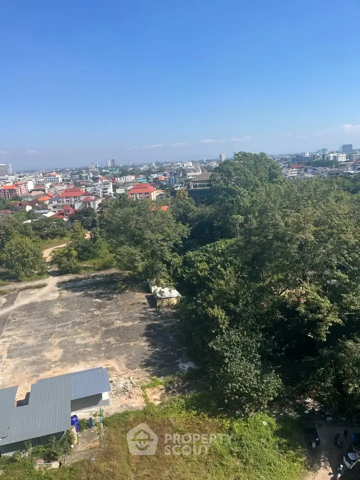 Stunning aerial view of urban landscape with lush greenery and city skyline.