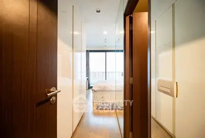 Spacious bedroom with large windows and wooden flooring, offering a cozy and inviting atmosphere.