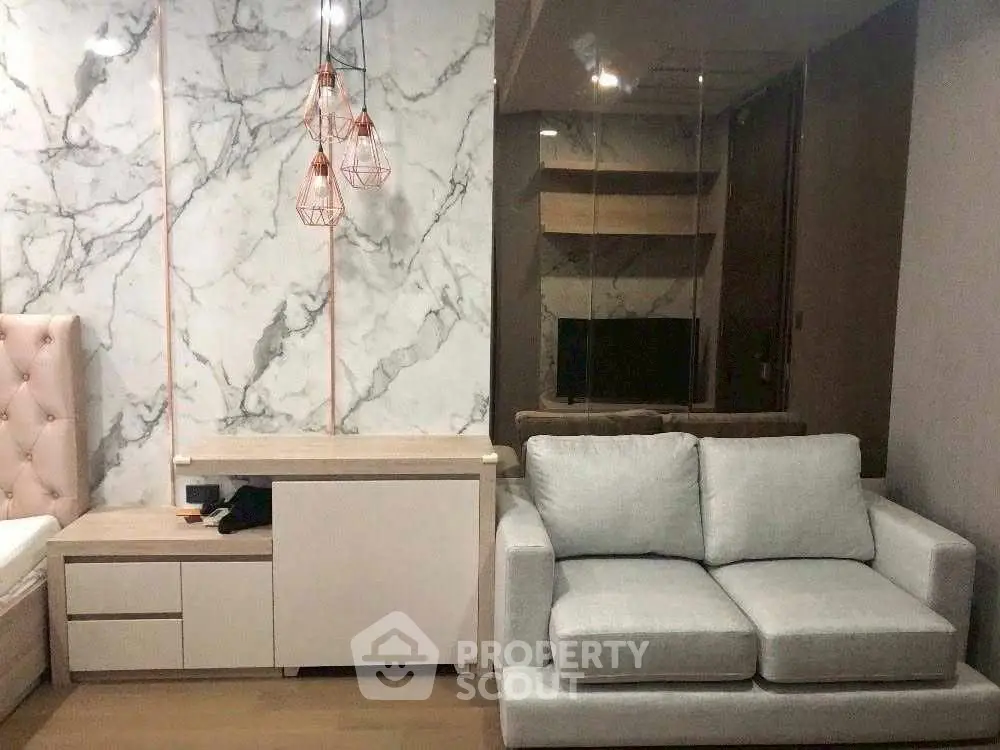 Modern living room with stylish marble wall and cozy sofa