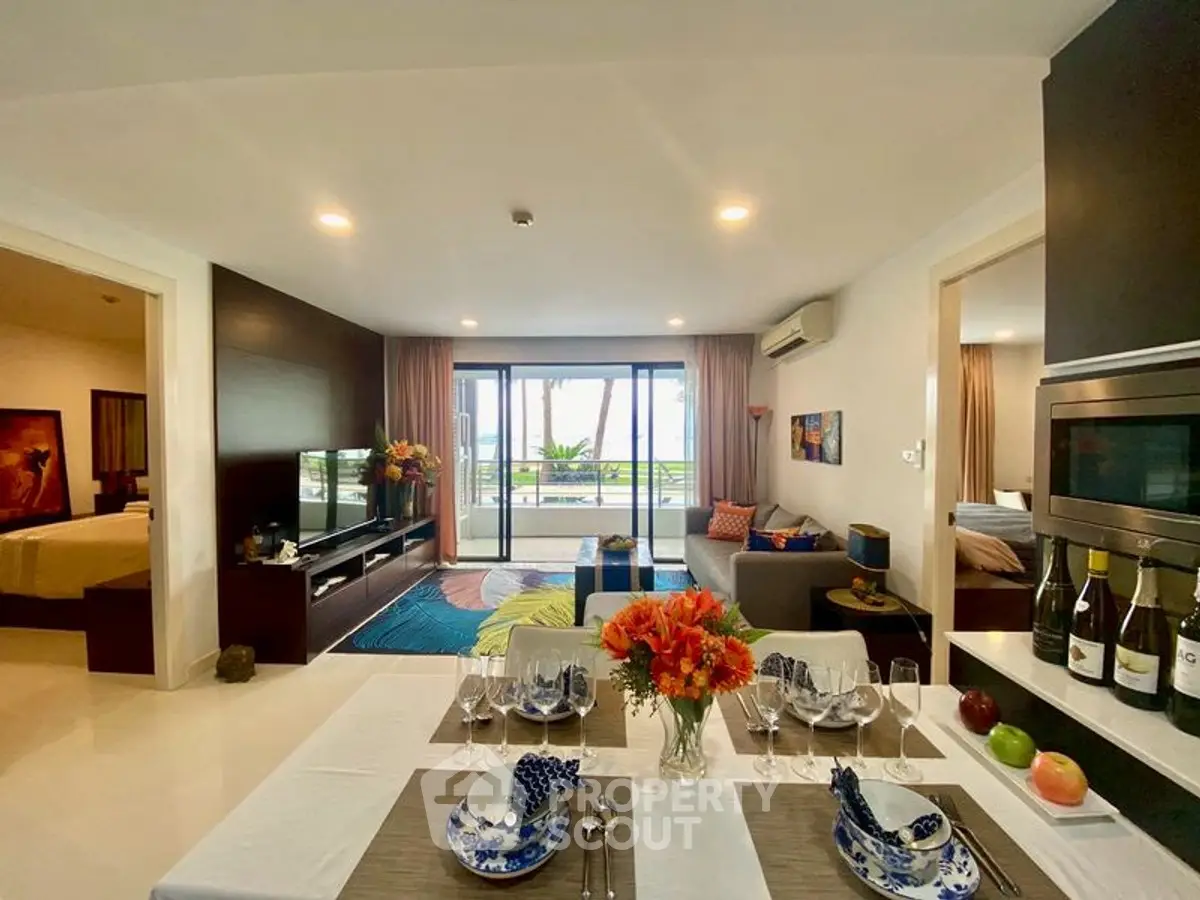 Luxurious open-plan living room with elegant dining area and stunning balcony view.