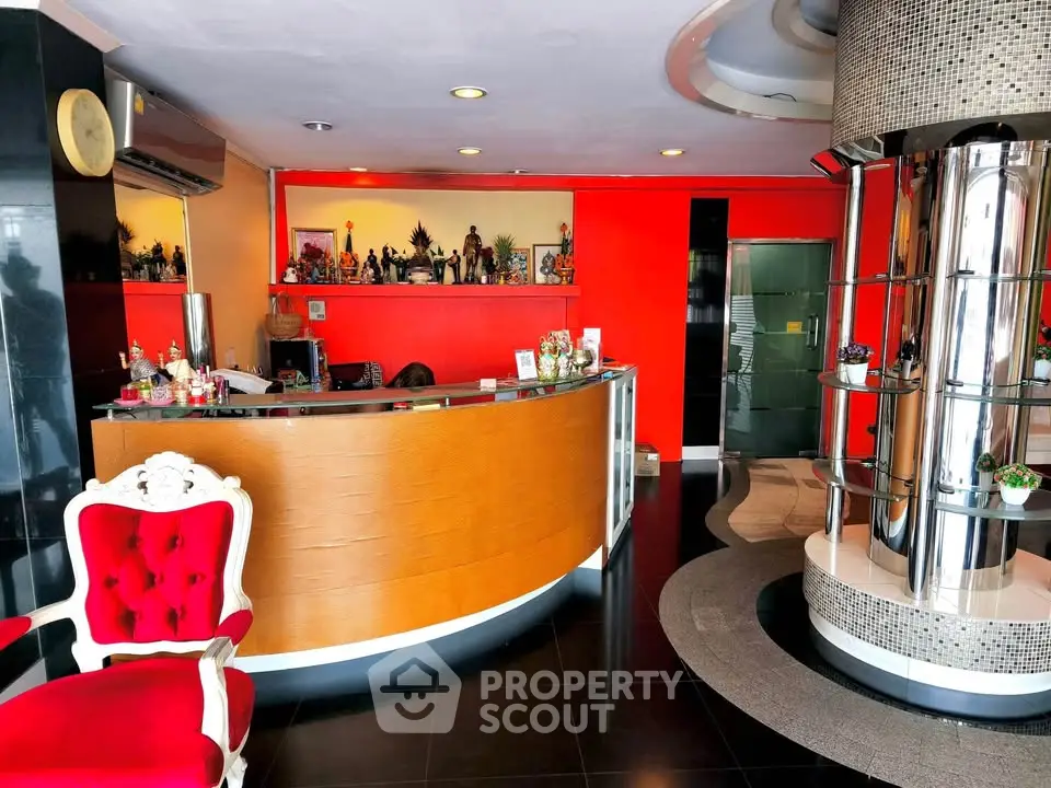 Stylish hotel lobby with modern decor and vibrant red accents