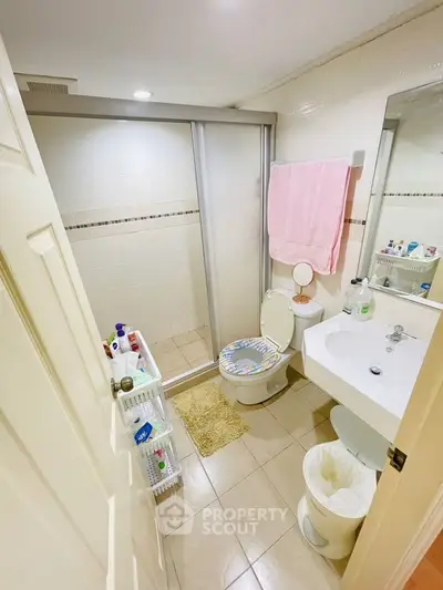 Cozy bathroom with shower, modern fixtures, and ample storage space.