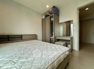 Spacious bedroom with modern furniture and ample storage space