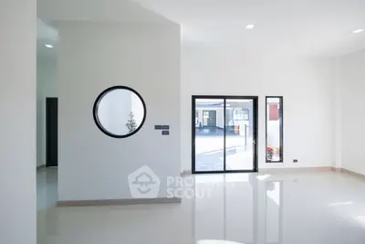 Spacious modern living room with large windows and minimalist design