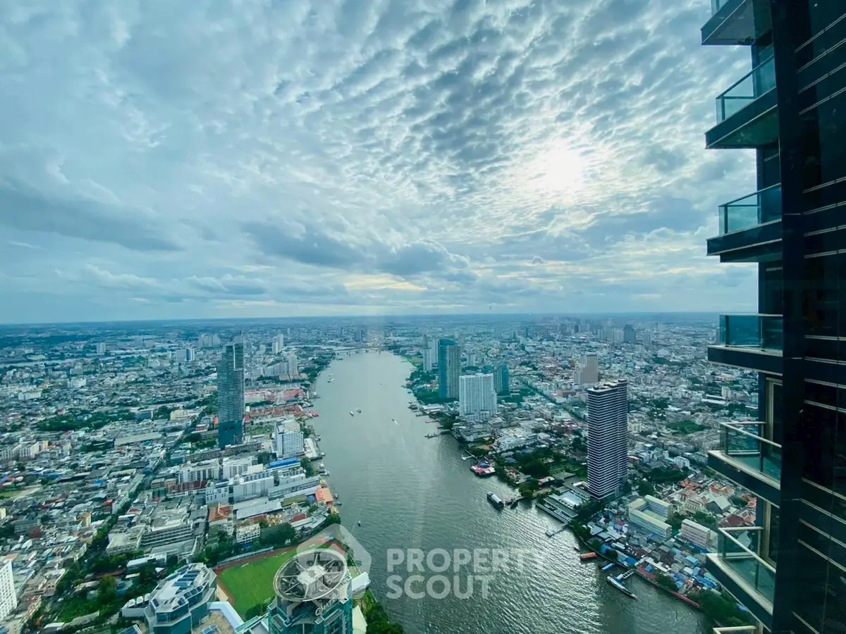 Stunning cityscape view from high-rise building overlooking river and skyline.