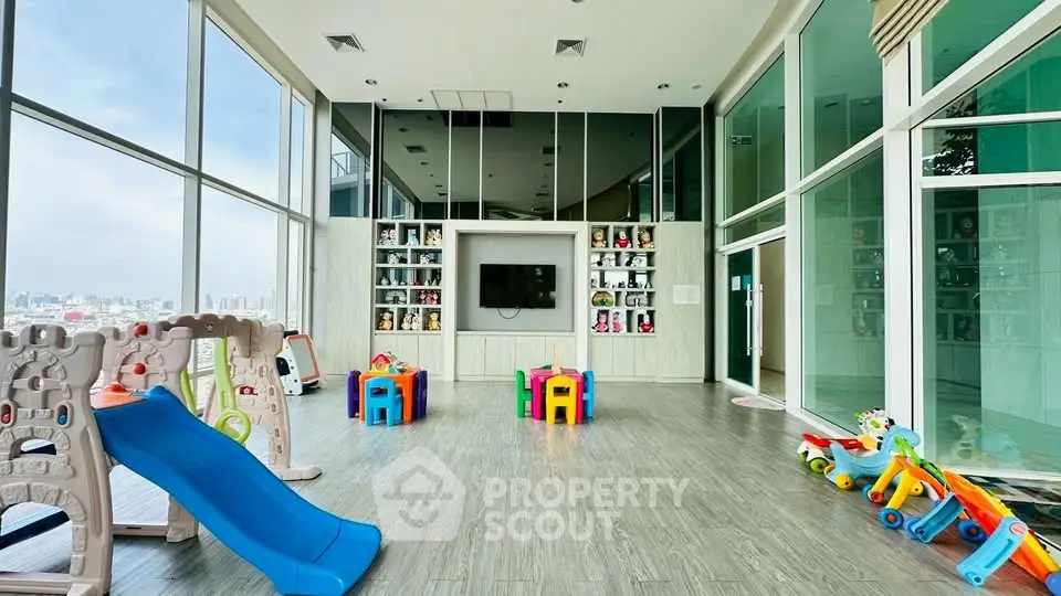 Spacious children's playroom with city view, featuring colorful toys and modern design.