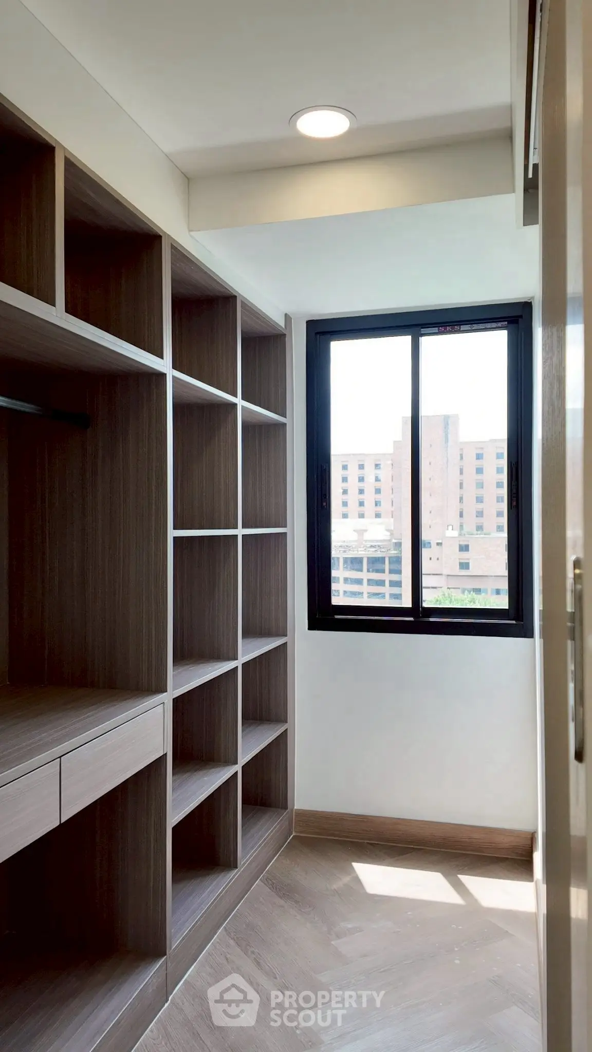 Spacious walk-in closet with natural light and city view