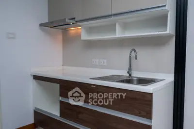 Modern kitchen with sleek cabinetry and stainless steel sink
