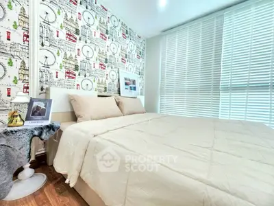 Cozy bedroom with stylish wallpaper and natural light through blinds.