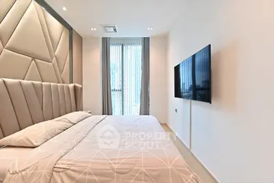 Luxurious modern bedroom with stylish decor and wall-mounted TV