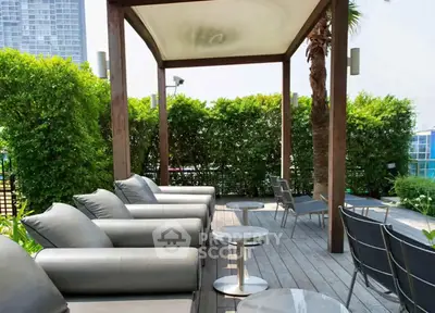 Luxurious outdoor terrace with modern seating and lush greenery, perfect for relaxation and entertaining.