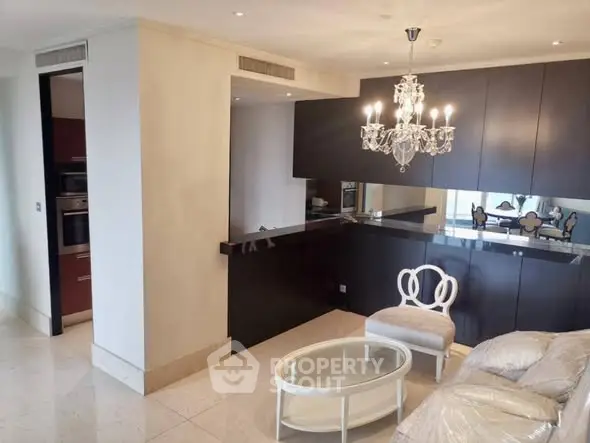 Elegant living room with chandelier and modern kitchen open layout