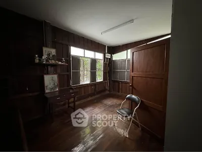 Cozy study room with wooden walls and natural light