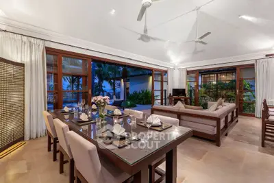 Luxurious open-plan living room with elegant dining area and garden view, perfect for entertaining.