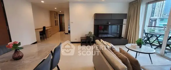 Spacious modern living room with elegant decor and balcony view in a high-rise apartment.