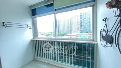 Bright balcony with city view and modern decor, perfect for relaxation.