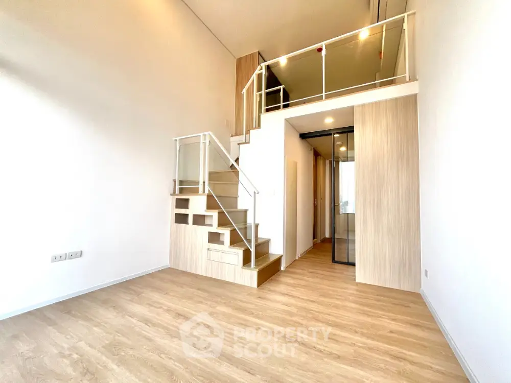 Modern loft apartment with wooden flooring and stylish staircase