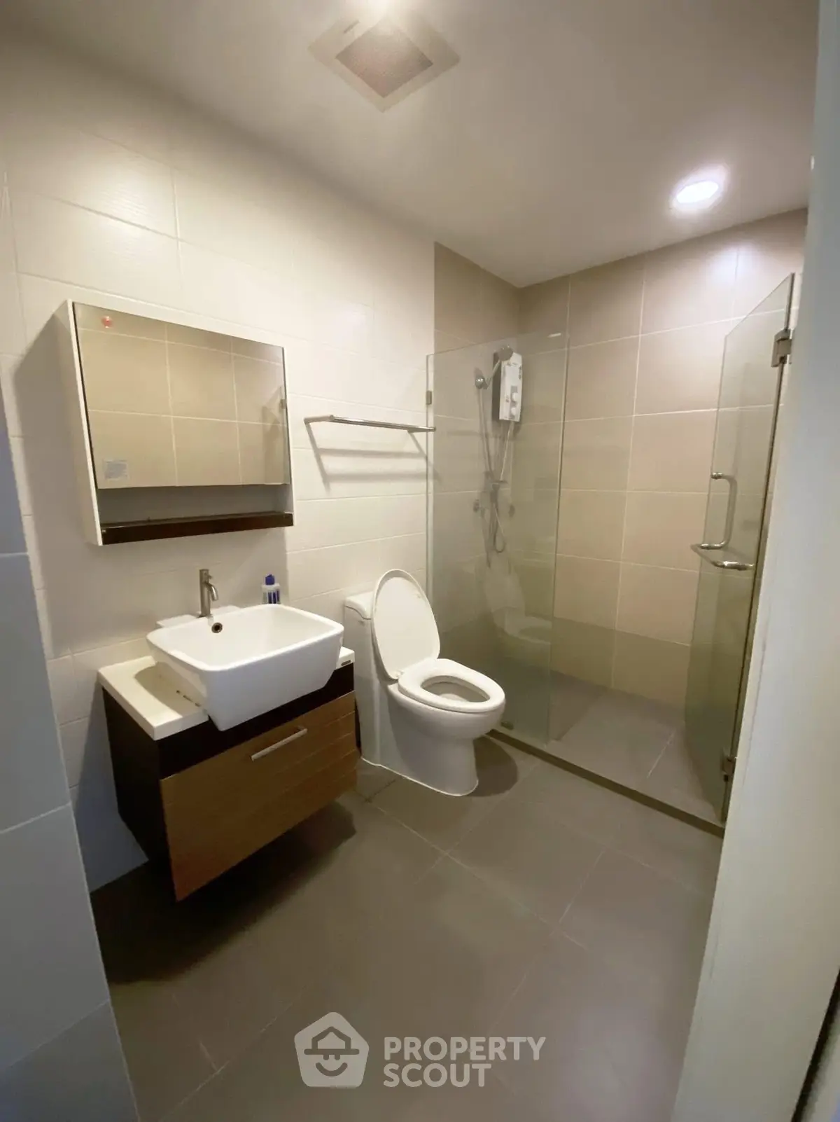 Modern bathroom with sleek fixtures and glass shower enclosure