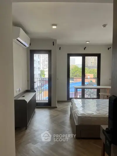 Modern bedroom with balcony view in urban apartment