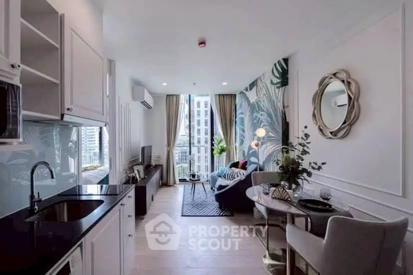 Chic modern living room with open kitchen, stylish decor, and city view balcony, perfect for urban living.
