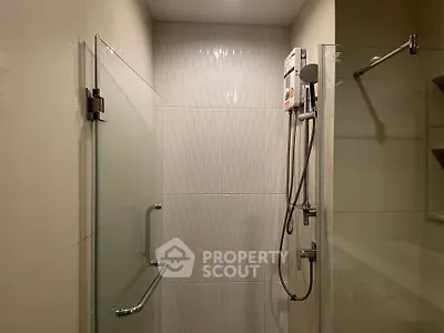 Modern bathroom with glass shower enclosure and sleek fixtures