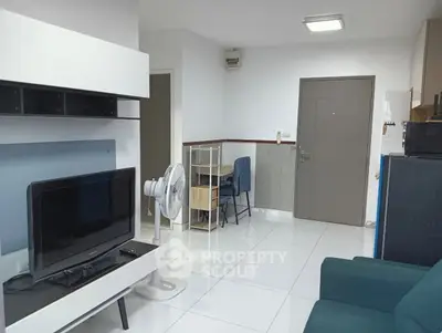 Modern living room with sleek furniture and TV setup, ideal for urban living.