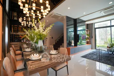 Luxurious open-plan living and dining area with elegant decor and natural light.