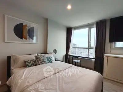 Modern bedroom with city view, stylish decor, and ample natural light.