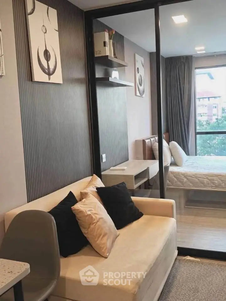 Modern studio apartment with stylish decor and large window view