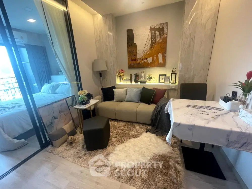 Modern living room with cozy decor and adjacent bedroom view