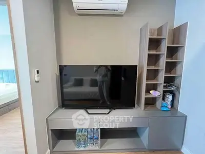 Modern living room with sleek TV unit and air conditioning, perfect for cozy entertainment.