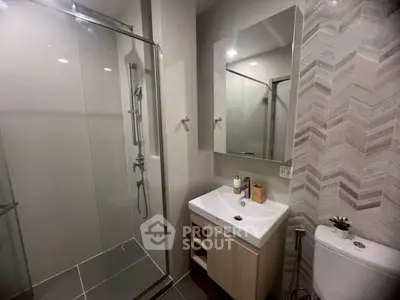 Modern bathroom with glass shower and stylish tile design