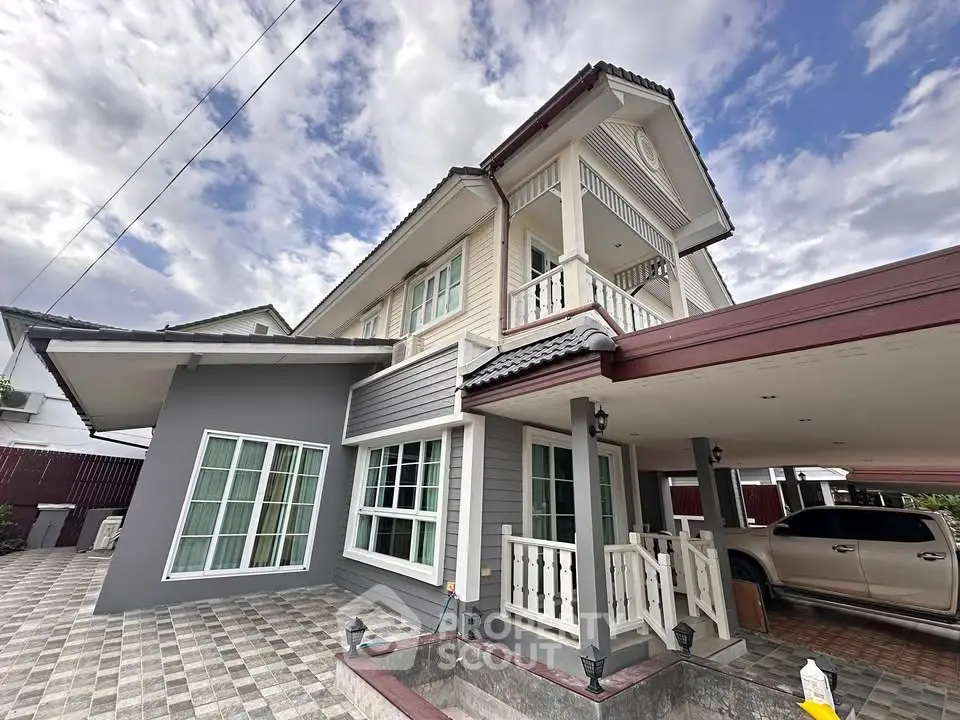 Stunning two-story house with modern architecture and spacious carport in a serene neighborhood.