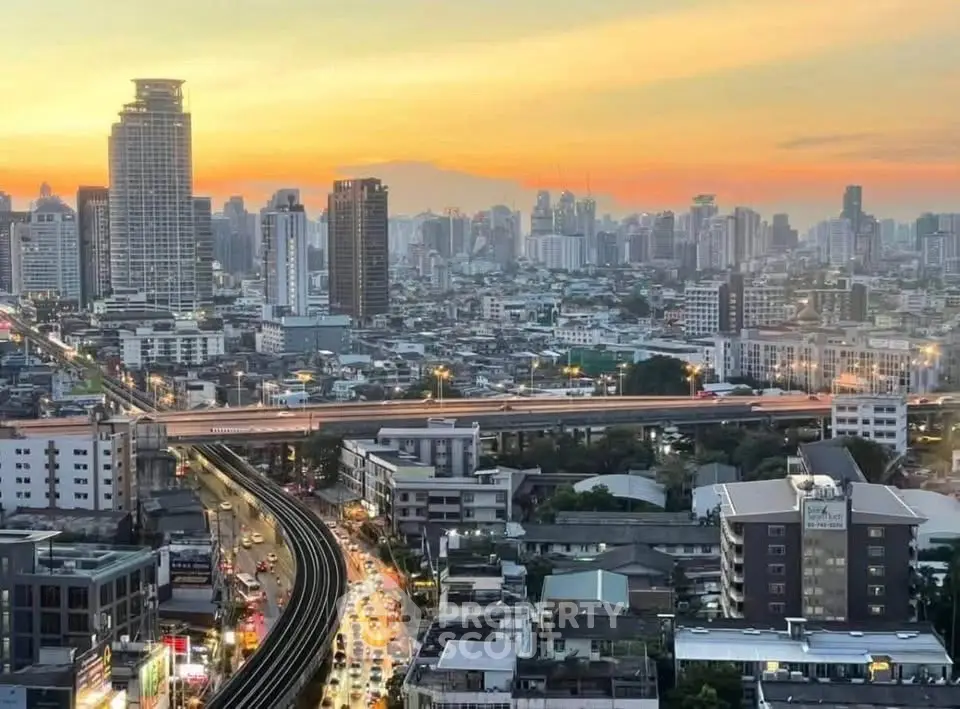 Stunning cityscape view with vibrant sunset over urban skyline and bustling streets.