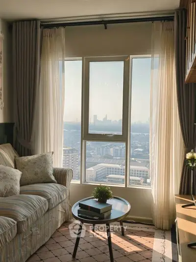 Cozy living room with stunning city view, featuring elegant sofa and stylish decor.