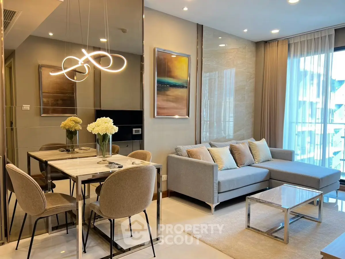 Modern living room with elegant decor, featuring a cozy sofa, stylish dining area, and large windows for natural light.