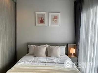 Cozy bedroom with a neatly made bed, soft lighting, and tasteful wall art, perfect for relaxation and comfort in a modern home.