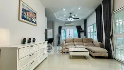 Spacious living room with modern decor and large windows