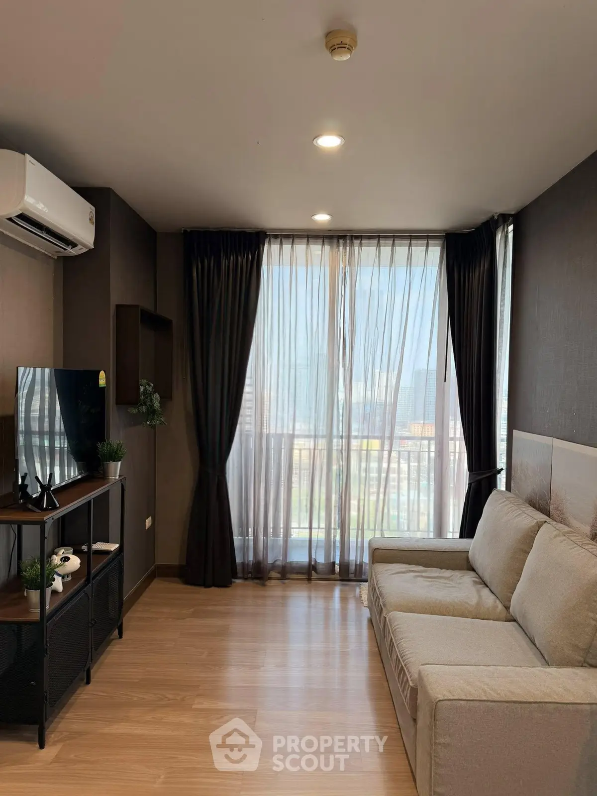 Modern living room with large window and cozy sofa in stylish apartment.