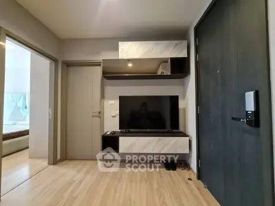Modern living room with sleek TV unit and wooden flooring