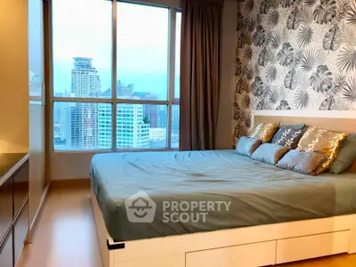 Stylish bedroom with city view, featuring modern decor and large windows for natural light.
