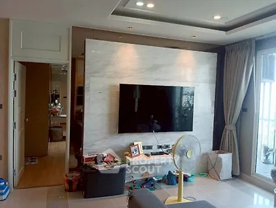 Modern living room with marble TV wall and large windows