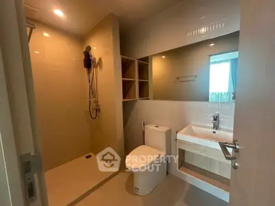 Modern bathroom with sleek fixtures and spacious shower area in a contemporary home.