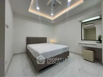 Modern minimalist bedroom with sleek design and ambient lighting