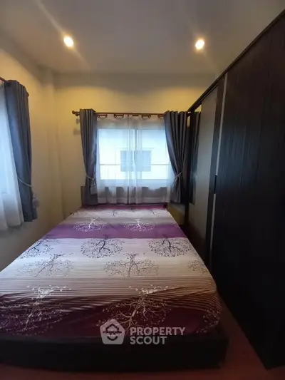 Cozy bedroom with stylish decor and ample natural light